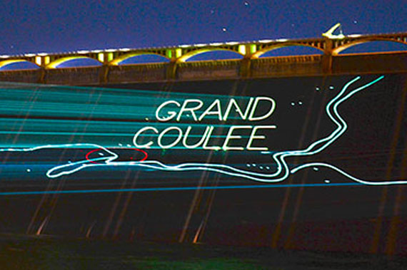 “Grand Coulee” light display projected on a dam wall at night.
