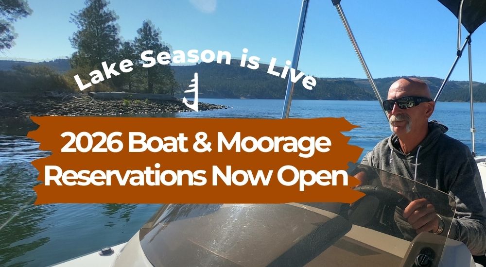 Promo graphic: man driving a boat with text “2026 Boat & Moorage Reservations Now Open”.